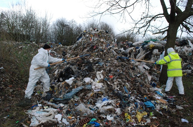 Environment Agency staff sifting through a waste pile in Hillingdon