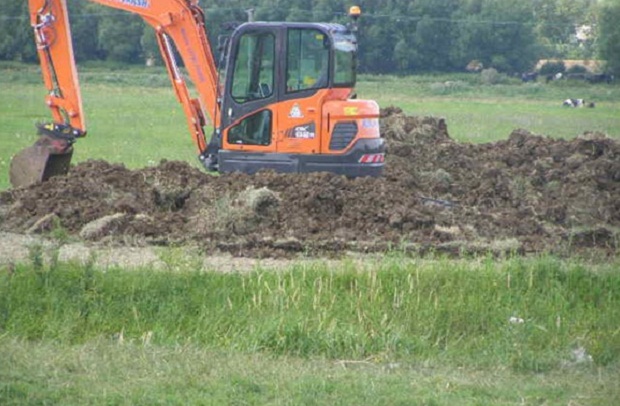 Photo shows an excavator carrying out repair work to North Barrier, near Muchelney on the Somerset Levels and Moors