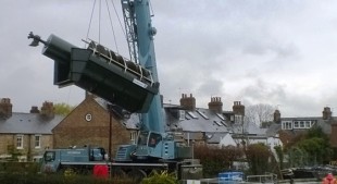 A hydropower screw generator being swung into position