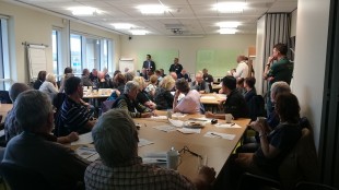 The room of flood wardens sitting in a large group session. 
