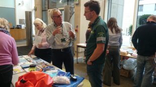 A flood warden and an EA officer talking. 