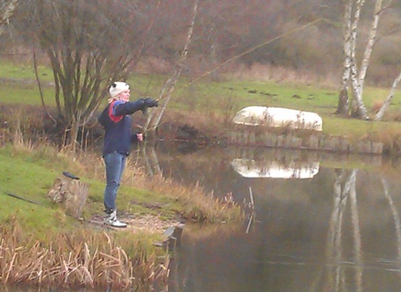 Woman fishing on bank