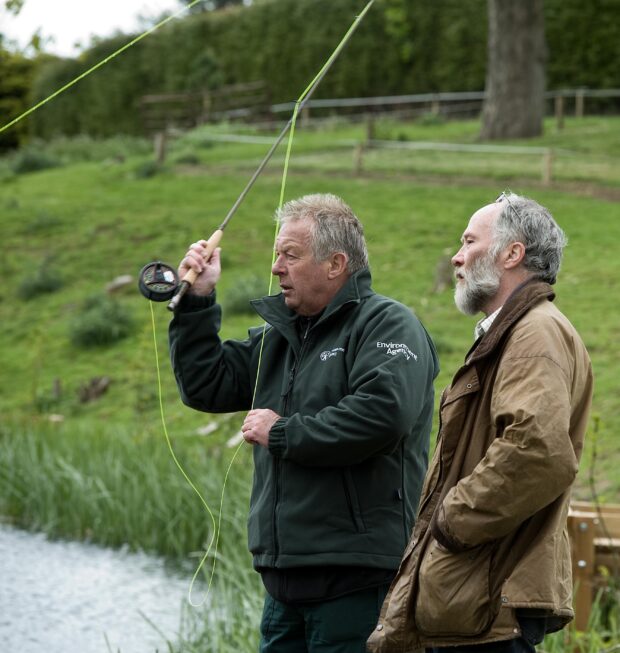 Two men learning how to fly fish