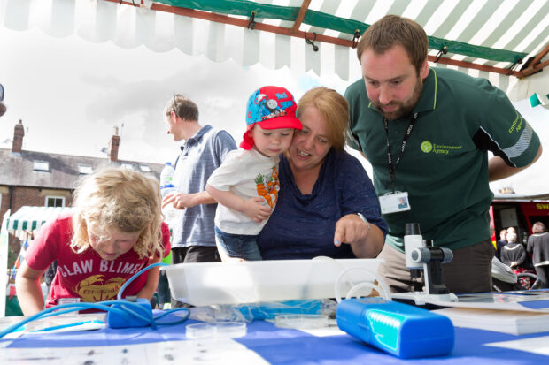 Local children trying their hand and water sampling with our fisheries team