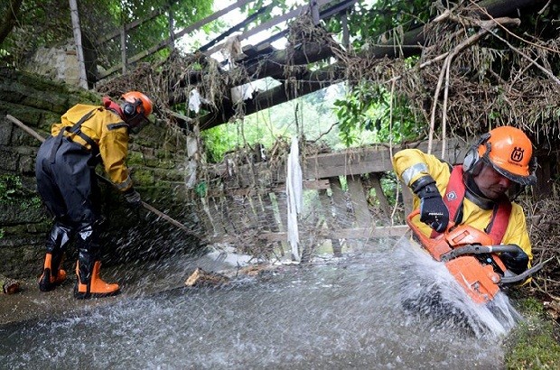 Dated: 05/07/2012 Environment Agency staff clearing a water course of debris from last weeks floods in Lanchester, County Durham, ahead of forecasted torrential rain which is due to hit areas of the UK over the next few days.