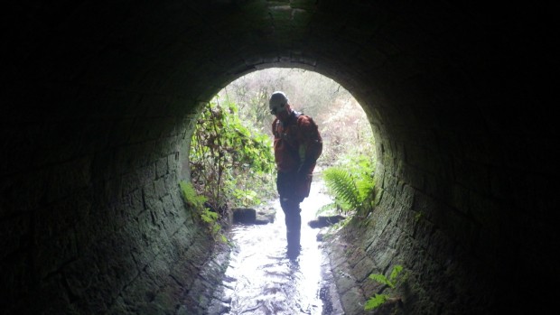 A member of the confined spaces team inspects a tunnel