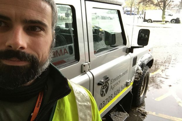 Volunteer Sam Chaplin in the snow with 4x4 vehicle