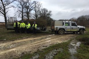 Environment Agency staff with vegetation collected after carrying out tree maintenance work 