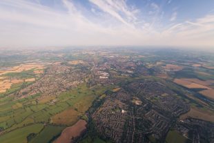 Aerial view of a town surrounded by farmland