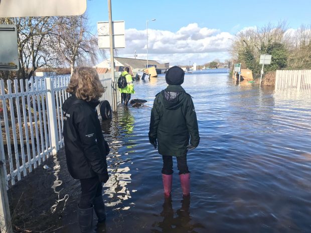 Image of two people in flood water