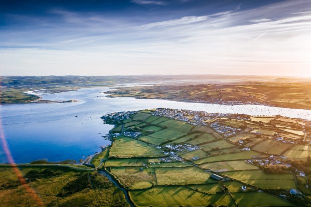 aerial image of green fields and a river