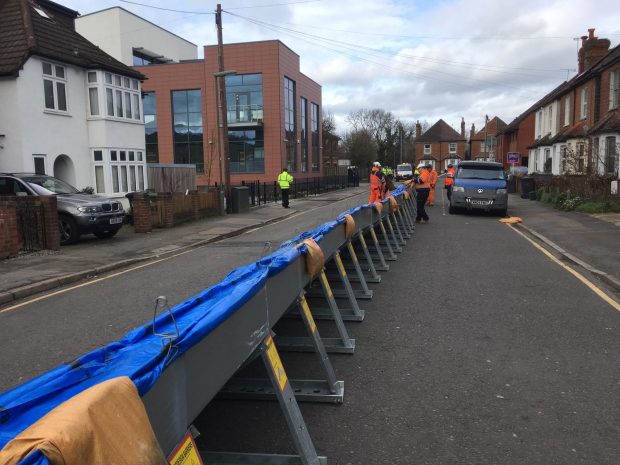 temporary flood barriers in the middle of a road