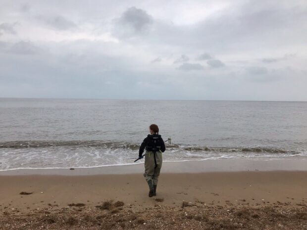 Ruth Sanderson on a beach sampling bathing water