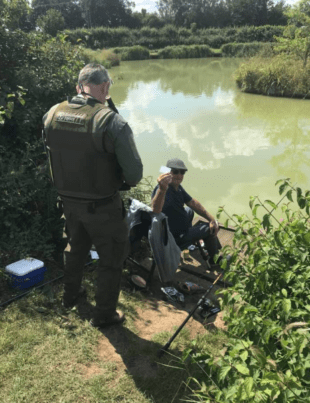 EA fisheries enforcement officer checks a fishing licence