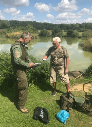 EA fisheries enforcement officer checks a fishing licence