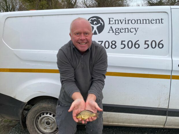 Phil Wood, Leiston Youth Community Angling Society volunteer, holds one of the fish that was given to the group by the Environment Agency as part of a restocking project. 