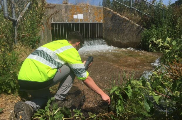 Environment Agency officer monitoring at a groundwater outfall on river tributary