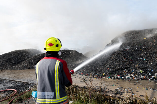 Image of fire staff putting out burning waste fire. 18-07-17 - Worksop Sandy Lane - Photographer Alex Skennerton (Multimedia and Photography Officer Nottinghamshire Fire and Rescue Service)