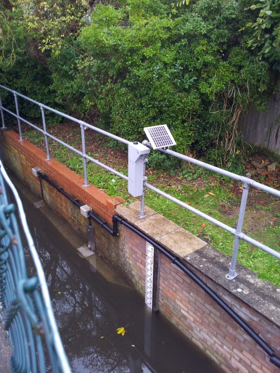 Radio operated camera mounted on riverbank that sends images of blocked river screens back to the office remotely, reducing staff travel time and flood risk. 