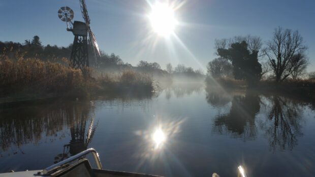 A picture of the Norfolk Broads taken from a boat.