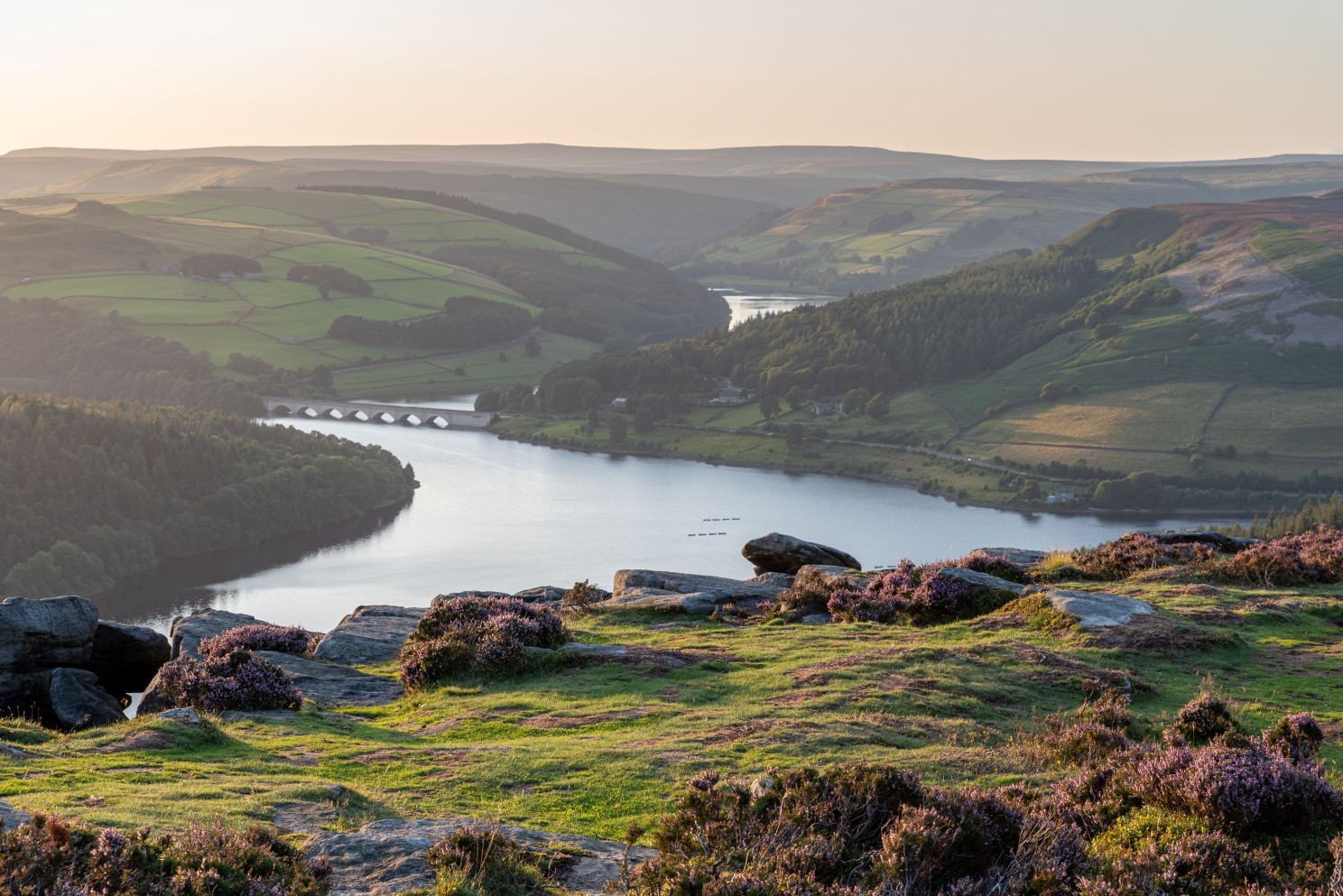 A scenic view of the Ashopton Viaduct, Ladybower Reservoir, and Crook Hill in the Peak District