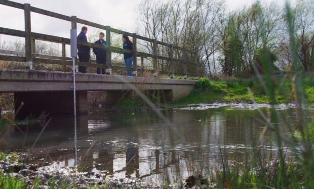 Blue Heart and East Sussex County Council staff viewing one of the new telemetry sensors.