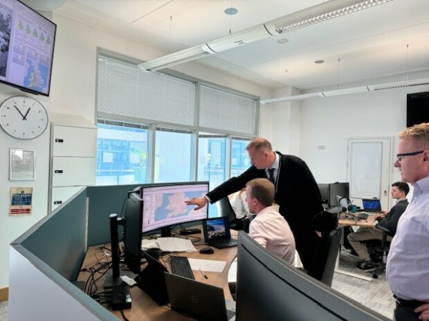 Environment Agency Chief Executive reviewing flood modelling on screen with colleague from Flood Forecasting Centre