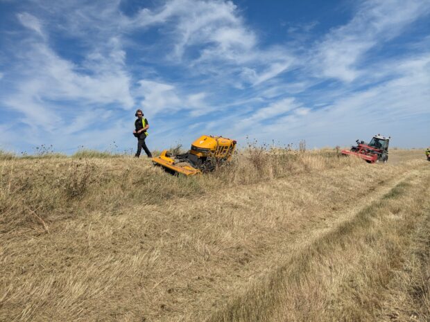 EA officer uses a robot mower to carry out maintenance on an embankment.