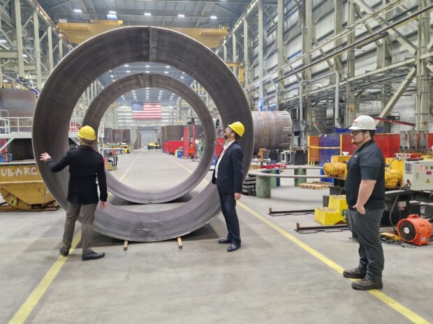 Two employees from the Office for Nuclear Regulation taking a tour of a nuclear manufacturing centre