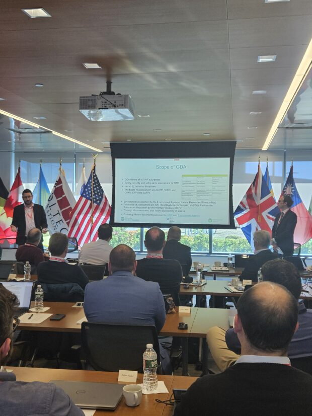 View of a workshop session at Holtec, people in a room facing a large screen