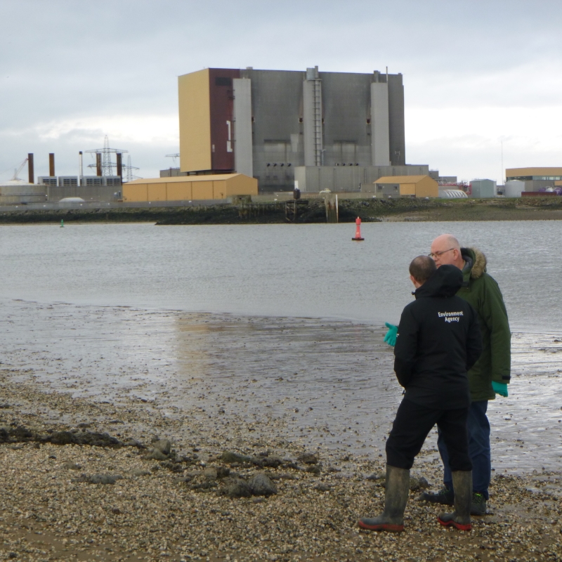 Two Environment Agency colleagues in front of a nuclear power station in Hartlepool.