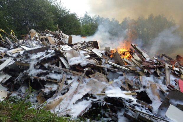 This image shows a pile of waste wood alight. 