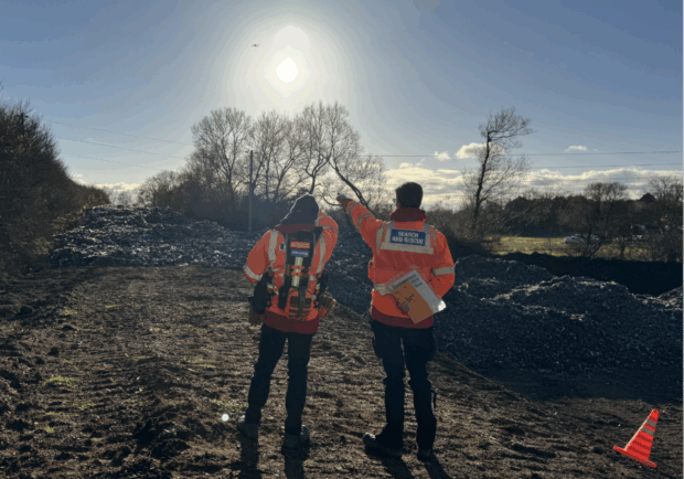 Fire and Rescue officers flying a drone above the waste at Kidlington illegal waste site. 