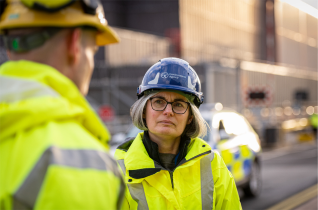 An Environment Agency officer speaks to a man out of shot.
