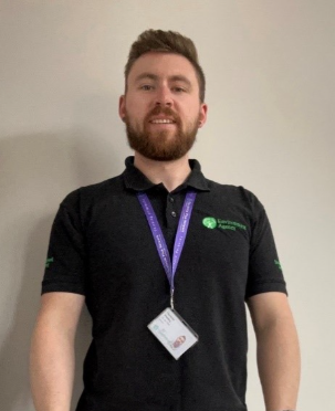 An Environment Agency officer in an Environment Agency branded top and lanyard.