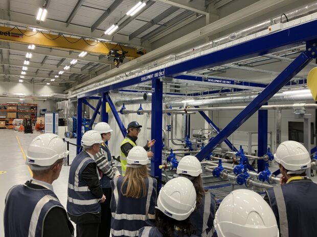 Picture inside the Rolls Royce works where a Rolls-Royce SMR engineer explains to the EA visitors how the steel modules will be constructed