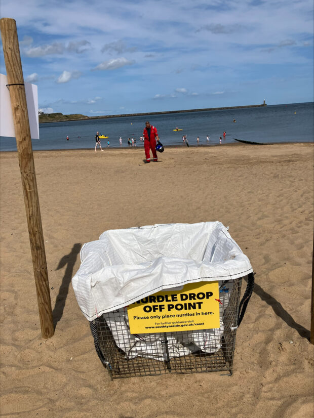 View of a Tyneside beach showing a nurdle drop off point, which looks like a bin.