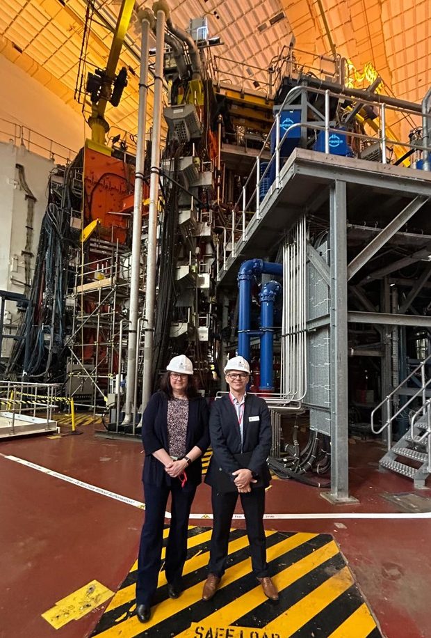 Environment Agency staff stand infront of the Joint European Torus (JET) fusion machine at Culham, Oxfordshire