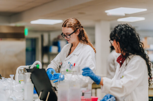 Photo shows EA scientists testing bathing water samples in a lab