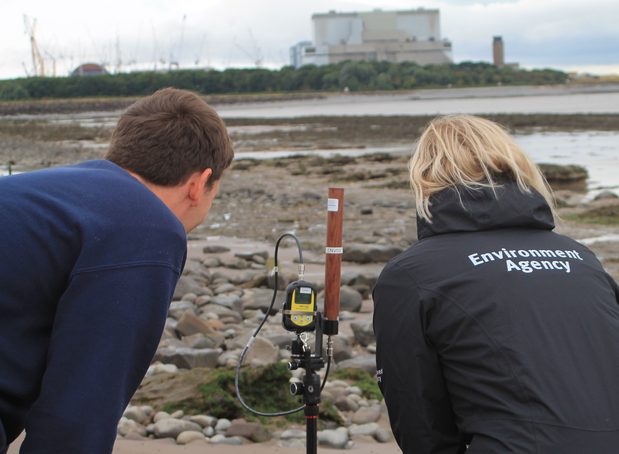 Technical staff using monitoring equipment near the Hinkley Point nuclear site
